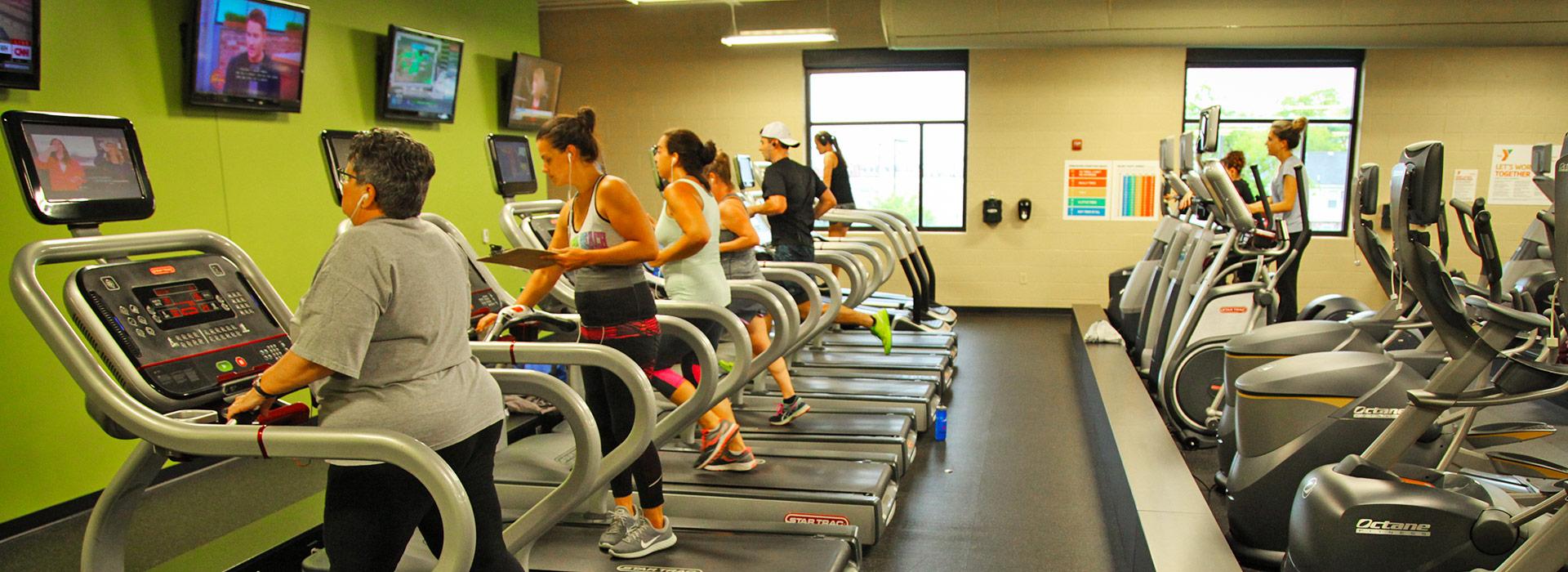 Members using cardio equipment, including treadmills, ellipticals, bikes and stair climbers in the wellness center at the YMCA on Granby